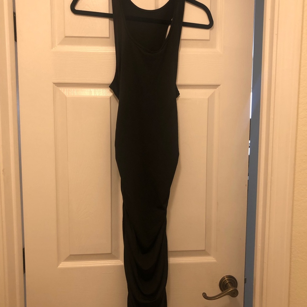 Racer back black dress with ruching on the sides.